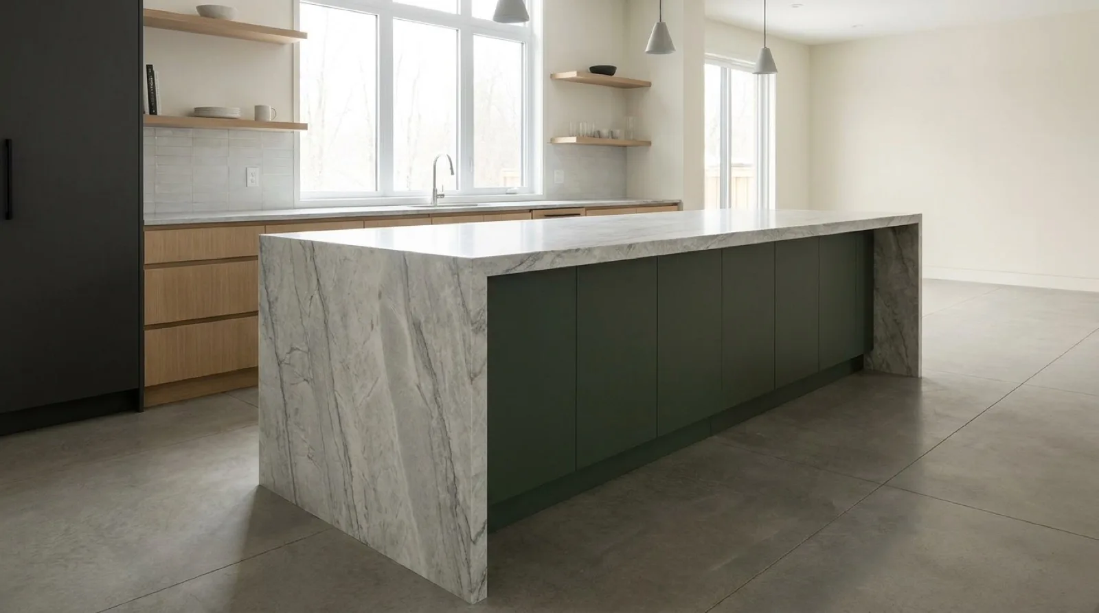 A large kitchen island with a veined stone waterfall top, the veining continuing down the mitred corner to the floor